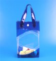 Blue transparent make up handle bag with button closure